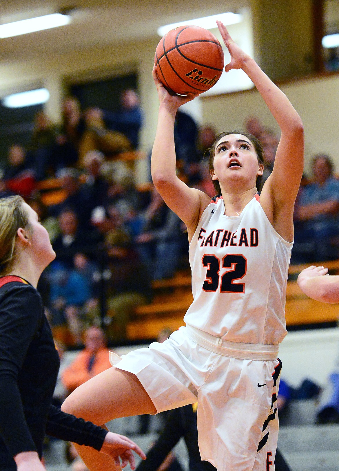 Flathead&#146;s Taylor Henley (32) drives to the basket in front of Missoula Hellgate&#146;s Bailee Sayler (22) at Flathead High School on Thursday. (Casey Kreider/Daily Inter Lake)