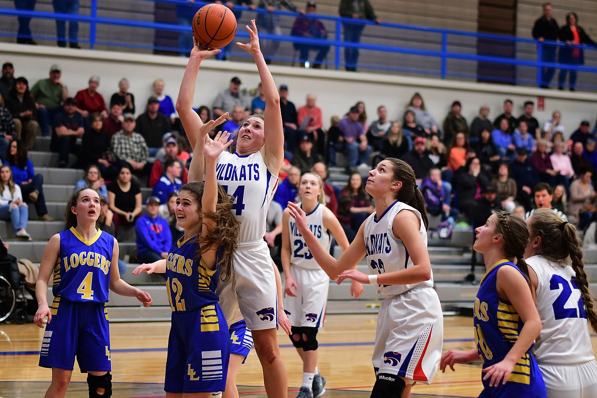 Josie Windauer puts back an offensive rebound over Libby's Alli Collins Thursday. (Jeremy Weber photo)