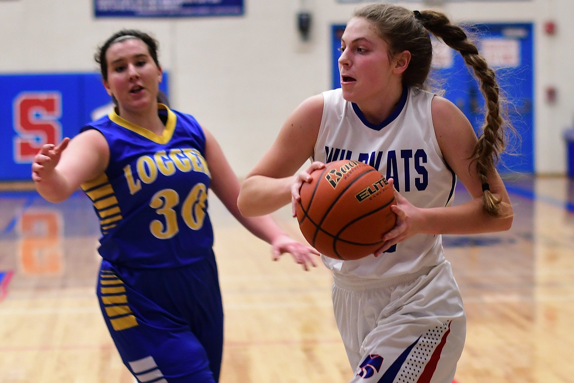 Hannah Schweikert takes the ball to the basket against Libby's Sammee Bradeen Thursday. (Jeremy Weber photo)