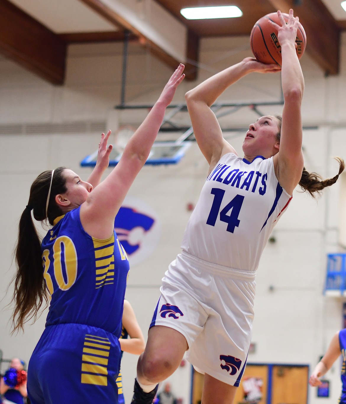 Josie Windauer goes up for a shot over Libby's Sammee Bradeen Thursday. (Jeremy Weber photo)