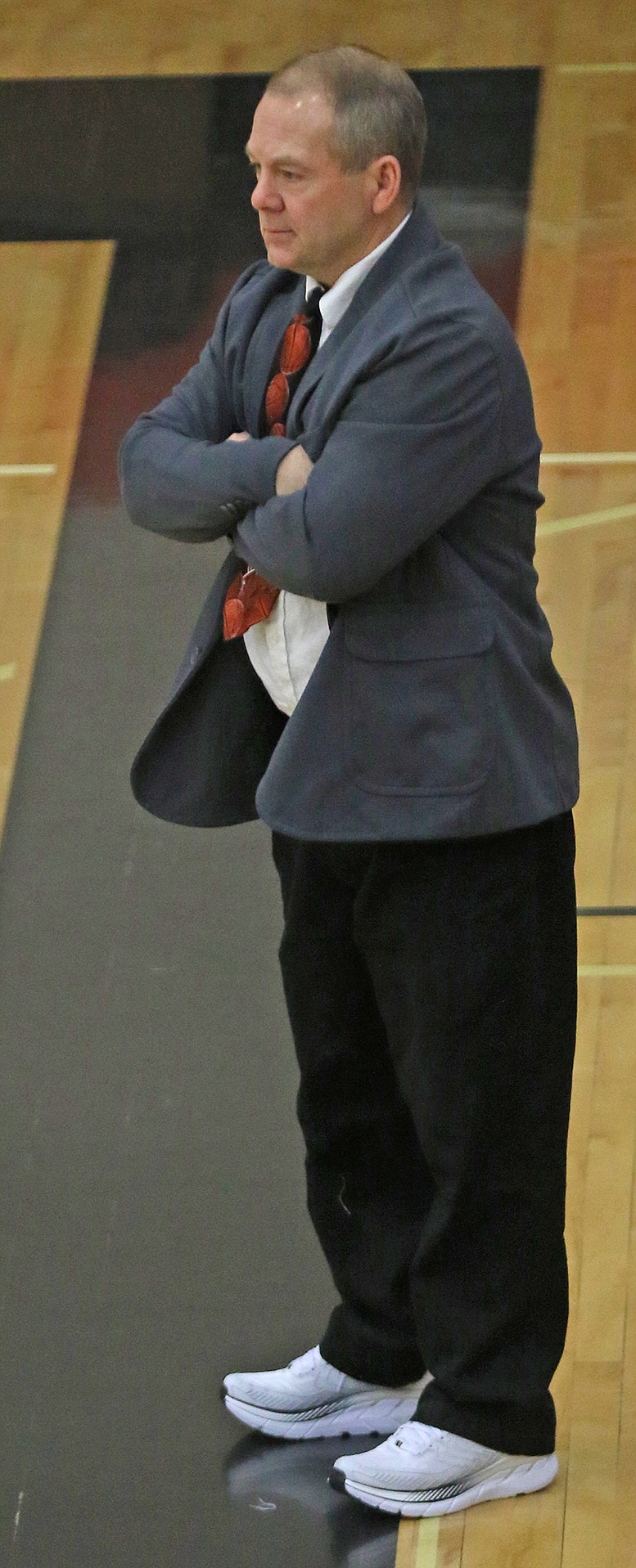 Ronan girls' coach Steve Woll wears suit, tie and sneakers for the occasion.