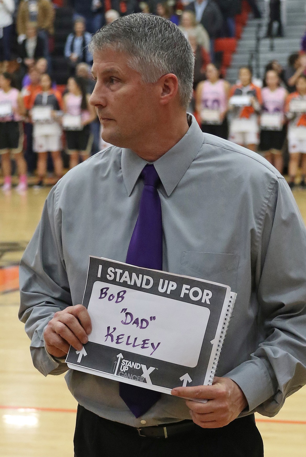 Polson boys' coach Randy Kelley with his sign.