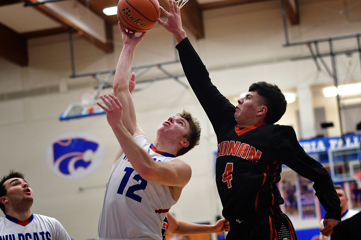 Drew Morgan takes the ball in against Ronan&#146;s Elijah Durheim Thursday. Morgan had a team-high 15 points in the Wildcats&#146; win over the Chiefs Thursday and hit a buzzer-beater three to down Corvallis Saturday. (Jeremy Weber photo)