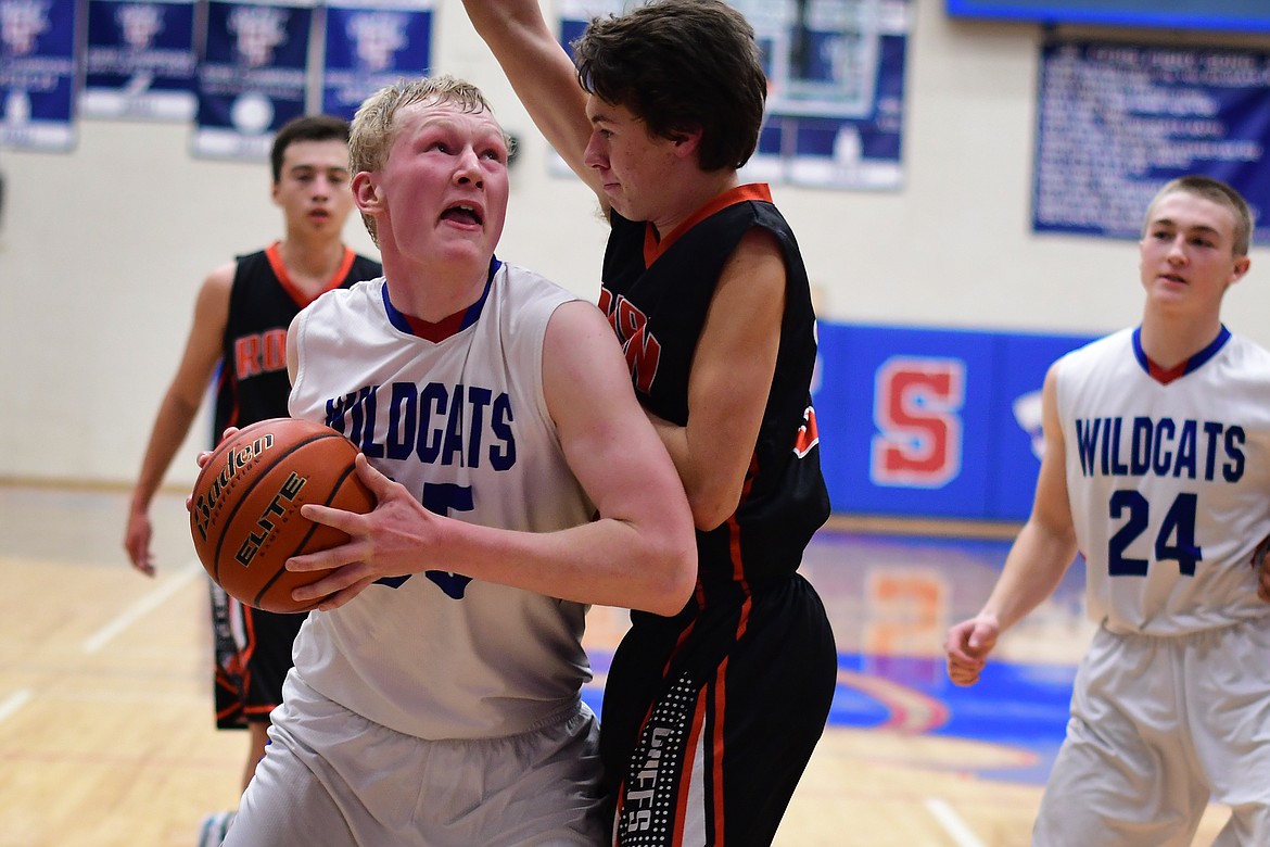 Sam Hovde takes the ball inside against Ronan&#146;s Zarec Couture Tuesday. (Jeremy Weber photo)