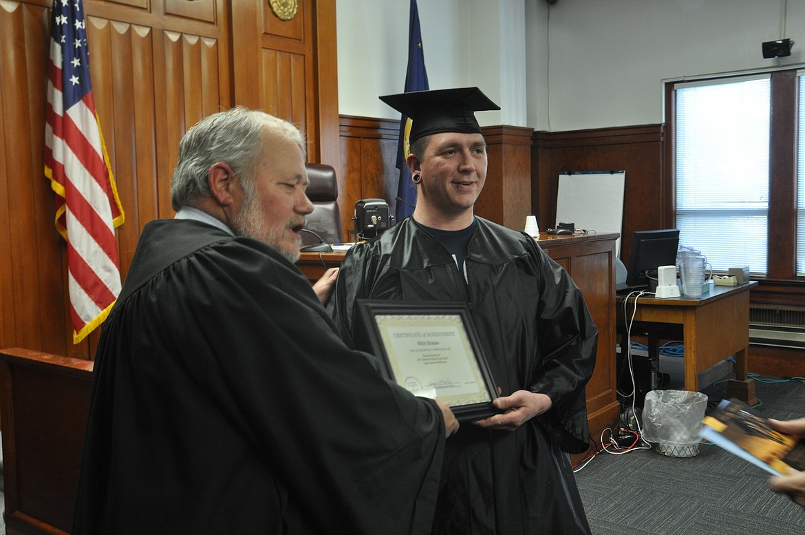 Nick Stasso, right, stands with District 20 Judge James A. Manley after he graduates from drug court Thursday, Jan. 24. (Ashley Fox/Lake County Leader)