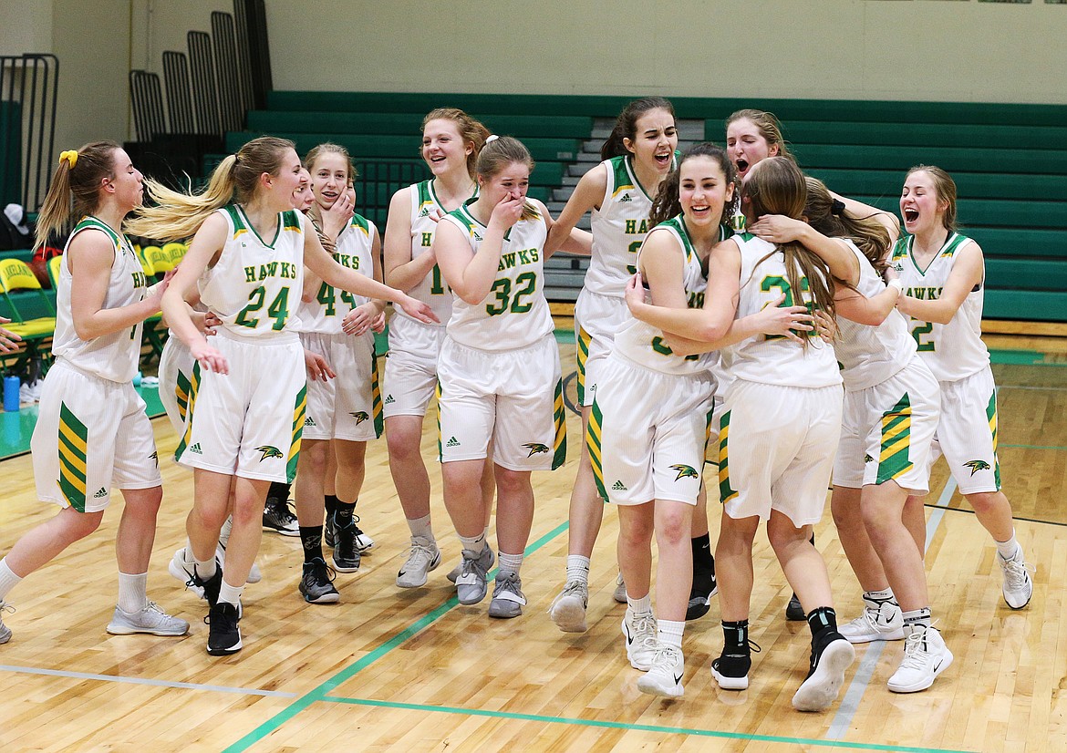 The lady Hawks celebrate their Region 1 Championship win over Moscow Friday night at Hawk Court. (LOREN BENOIT/Press)