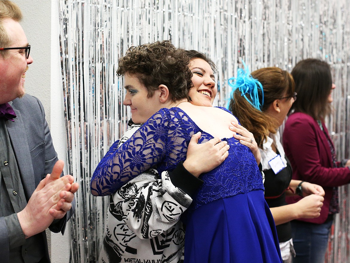 Gayle Frechette, in blue, gives her friend Charmaine Brown a hug as she walks down the red carpet at the beginning of Night to Shine Friday night at The Cause. (LOREN BENOIT/Press)