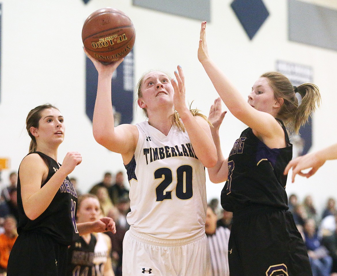 Timberlake&#146;s Brooke Jessen drives towards the basket between Kellogg defenders Kaitlin Senteney, right, and Taeya Sheppard during the 3A District 1 Championship game in Spirit Lake. The lady Tigers defeated Kellogg 52-19. (LOREN BENOIT/Press)