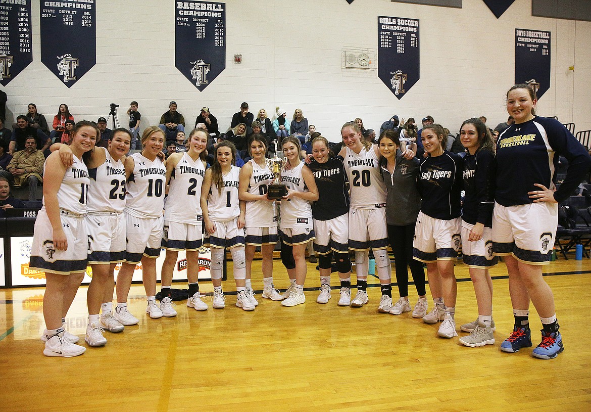 The Timberlake High School girls basketball team poses for a group photo with their 3A District 1 Championship trophy after defeating Kellogg 52-19. (LOREN BENOIT/Press)