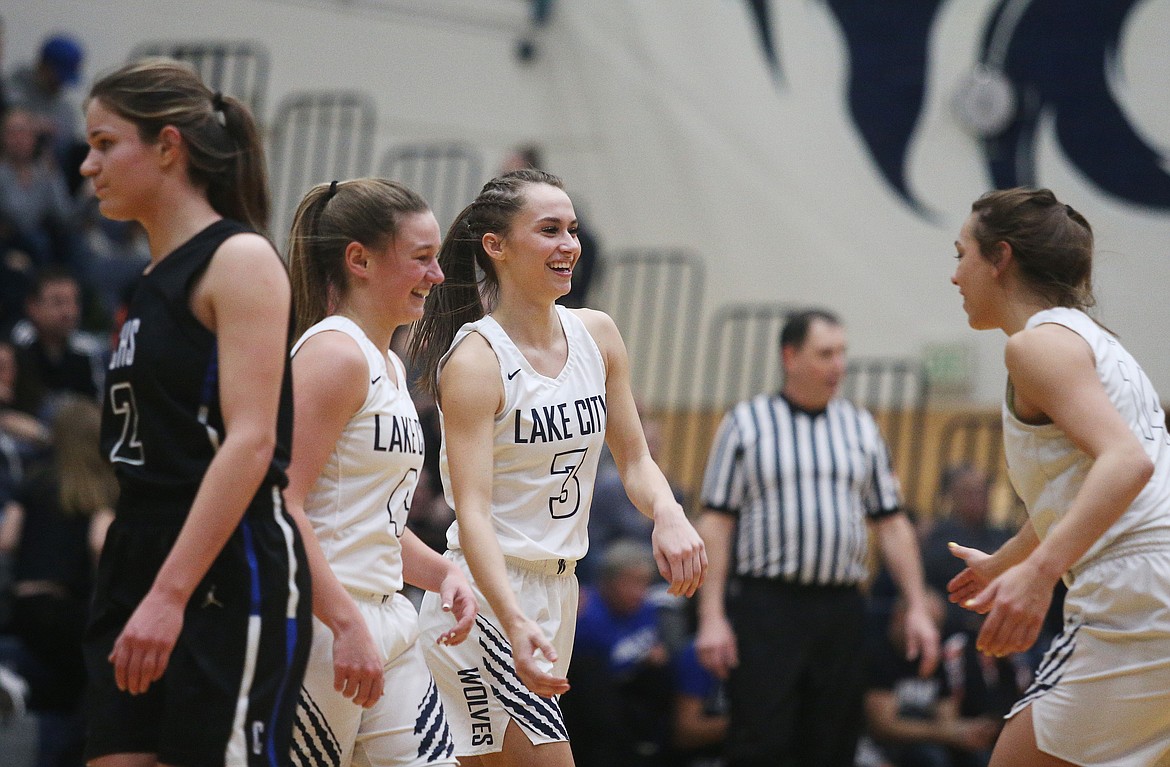 LOREN BENOIT/Press
From left, Lake City players Chloe Teets, Klaire Mitchell and Dejah Wilson celebrate their 44-30 5A Region 1 championship win over Coeur d&#146;Alene on Tuesday night at Lake City High.