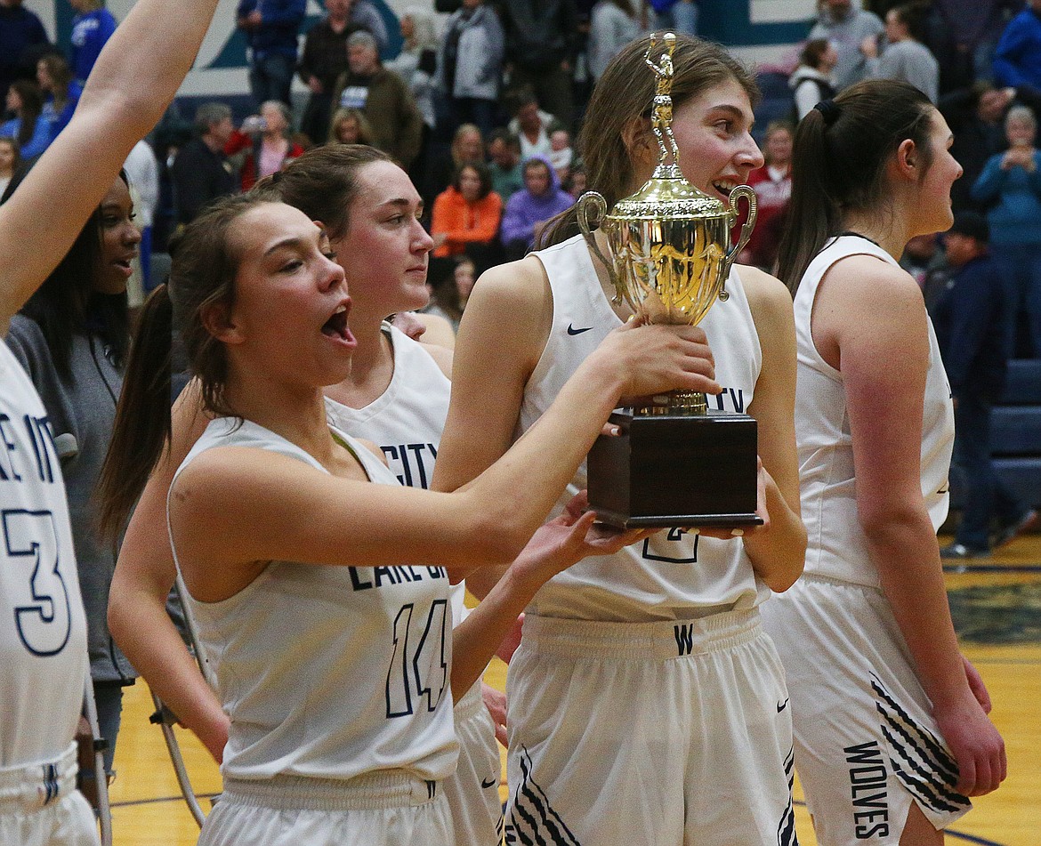 Lake City&#146;s Dejah Wilson, left, and Sara Muehlhausen hold the 5A Region 1 Championship trophy after defeating Coeur d&#146;Alene 44-30. (LOREN BENOIT/Press)