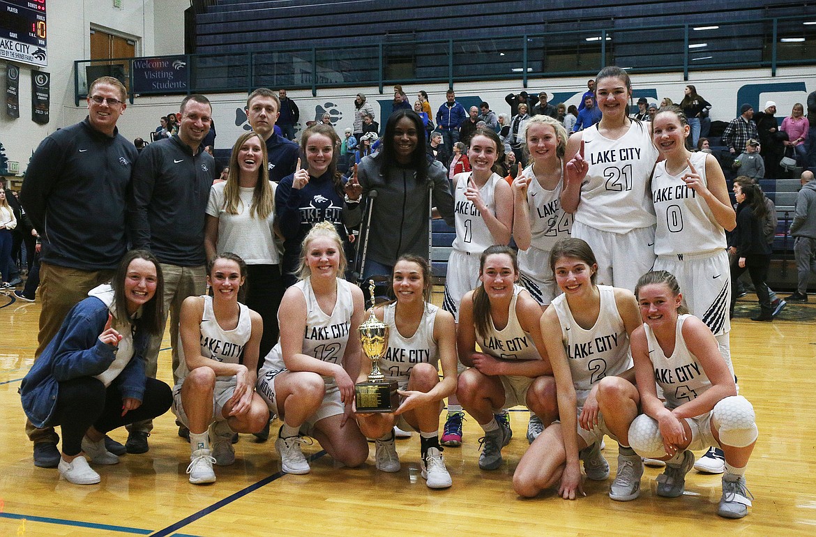 The Lake City High School girls varsity basketball team poses with their 5A Region 1 championship trophy after defeating Coeur d&#146;Alene 44-30. (LOREN BENOIT/Press)