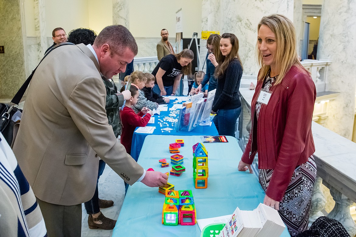 (Photo by OTTO KITSINGER/Idaho STEM Action Center)
Idaho Rep. Paul Amador, R-Coeur d&#146;Alene, learns about early science, technology, engineering, and mathematics initiatives from Children&#146;s Museum of Idaho administrative assistant Mary Fischer during STEM Matters Day at the state capitol. Hundreds of Idahoans gathered to explore and celebrate innovations in science, technology, engineering, and mathematics learning. The fourth annual event, organized by the Idaho STEM Action Center, attracted students, educators, elected officials, businesses, and STEM advocates from across the state.