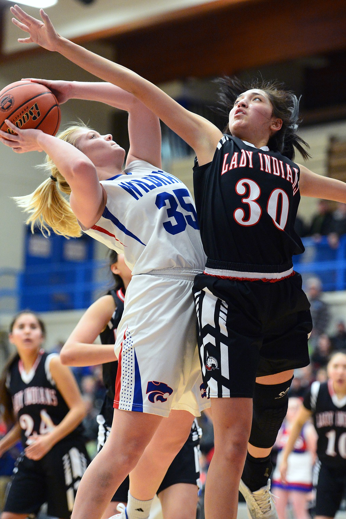 Columbia Falls' Trista Cowan (35) looks to shoot with Browning's Dulci Skunkcap (30) defending at Columbia Falls High School on Saturday. (Casey Kreider/Daily Inter Lake)