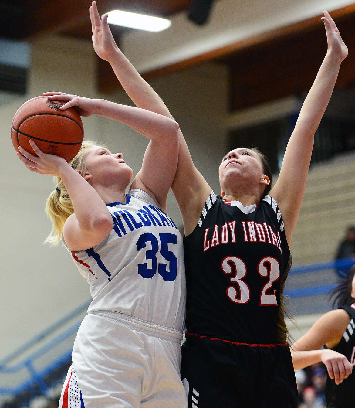 Columbia Falls' Trista Cowan (35) over Browning's Taylor Jordan (32) at Columbia Falls High School on Saturday. (Casey Kreider/Daily Inter Lake)