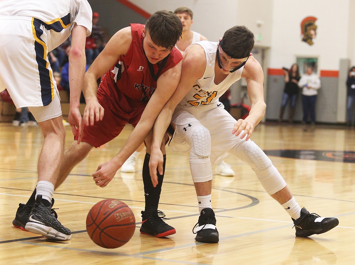 Seth Neely, right, of Genesis Prep and Kootenai&#146;s Triston Usdrowski battle for a loose ball during Friday night&#146;s game.