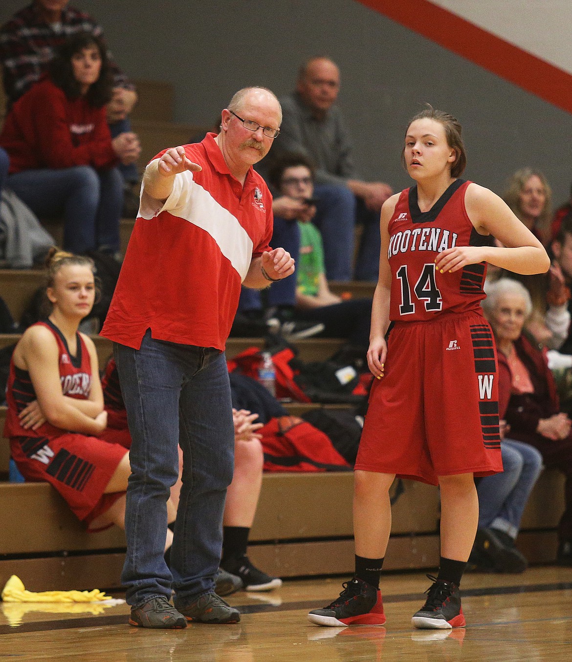 Kootenai girls basketball coach Doug Napierala gives Lauren Addington some instructions during Friday night&#146;s game against Genesis Prep.