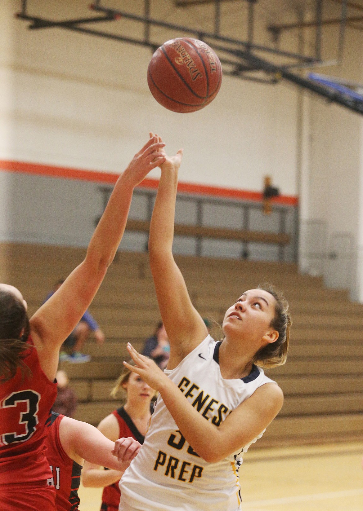 Genesis Prep forward Emily Martinez and Kootenai&#146;s Jacey Grange battle for a rebound.