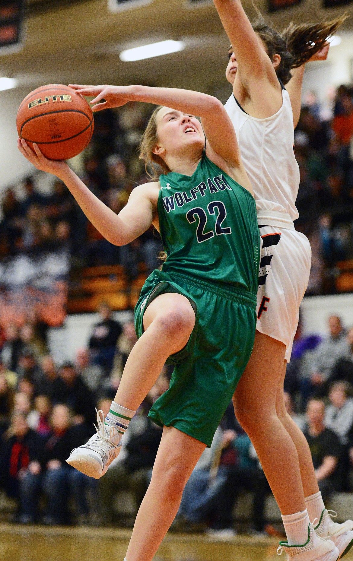 Glacier's Ellie Keller (22) drives to the hoop against Flathead's Taylor Henley (32) during a crosstown matchup at Flathead High School on Tuesday. (Casey Kreider/Daily Inter Lake)