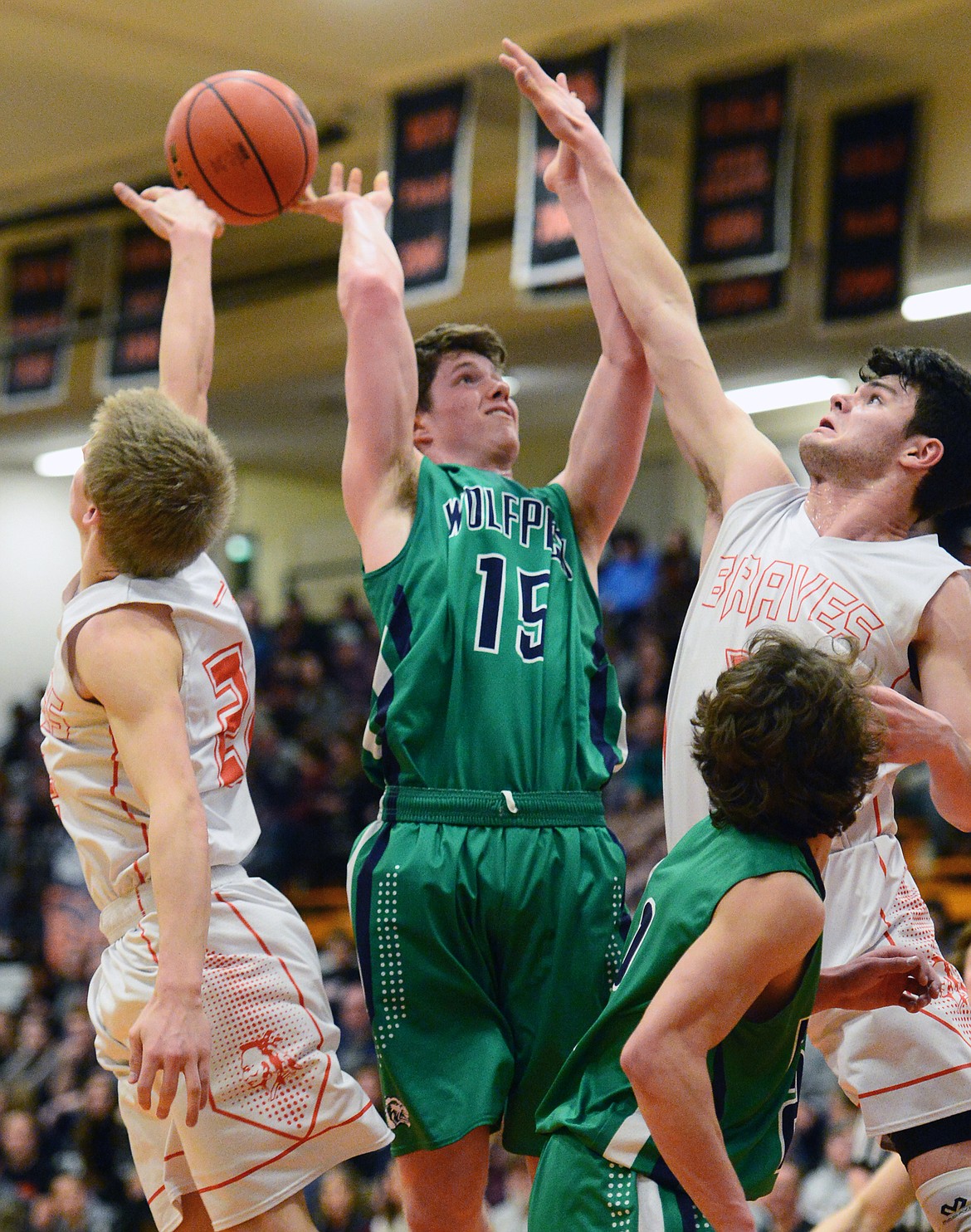 Glacier's Drew Engellant (15) has his shot blocked by Flathead's Seth Moon (22) but is fouled by Gabe Adams (33) during a crosstown matchup at Flathead High School on Tuesday. (Casey Kreider/Daily Inter Lake)