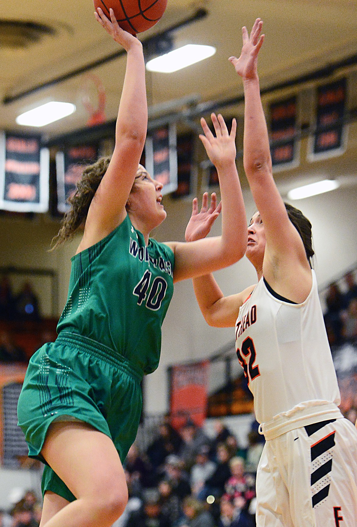 Glacier's Raley Shirey (40) goes to the hoop against Flathead's Taylor Henley (32) during a crosstown matchup at Flathead High School on Tuesday. (Casey Kreider/Daily Inter Lake)