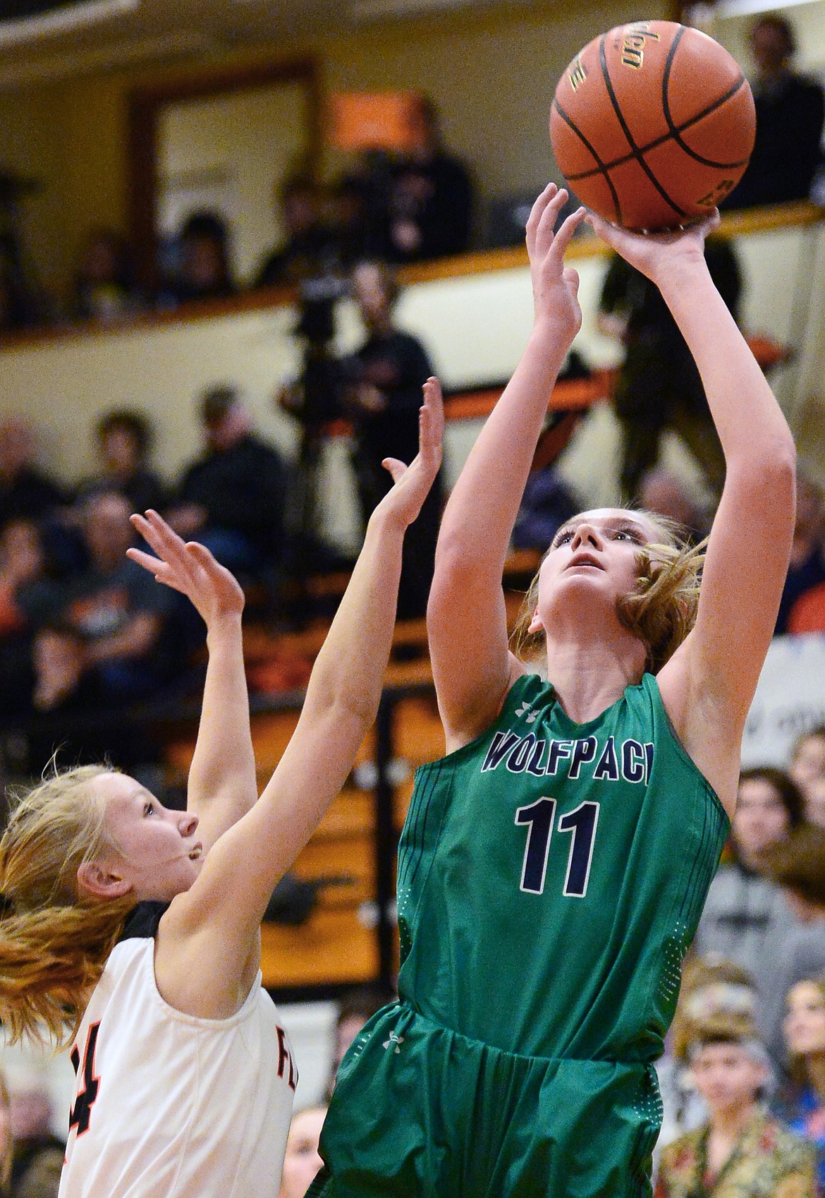 Glacier's Kaileigh Crawford (11) goes to the hoop against Jenna Johnson (14) during a crosstown matchup at Flathead High School on Tuesday. (Casey Kreider/Daily Inter Lake)