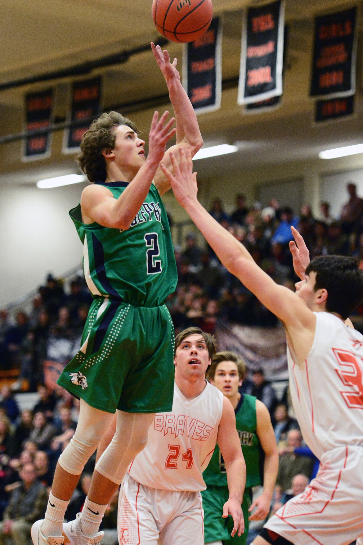 Glacier's Drew Deck (2) drives to the hoop over Flathead's Gabe Adams (33) during a crosstown matchup at Flathead High School on Tuesday. (Casey Kreider/Daily Inter Lake)