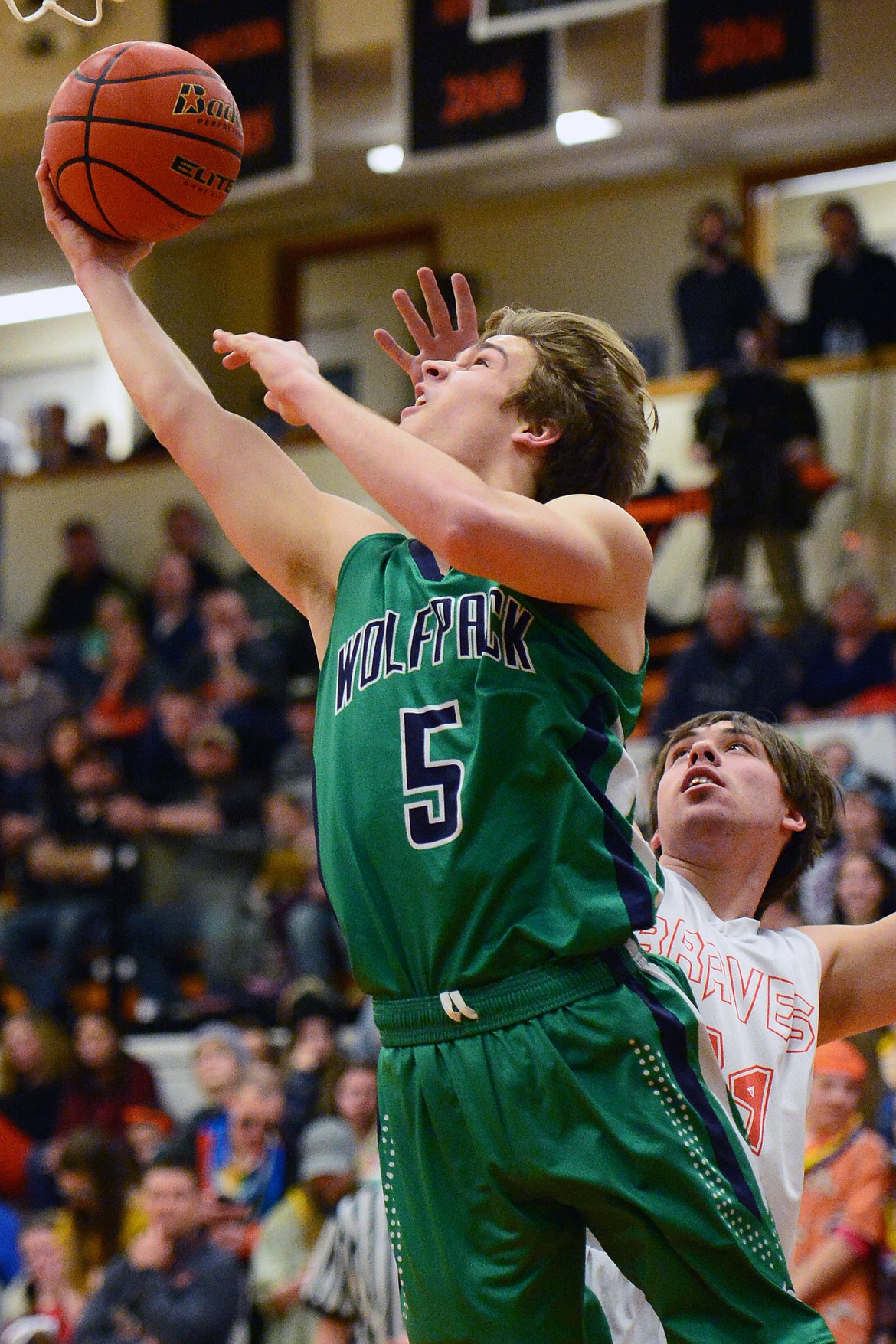 Glacier's Ethan Baines (5) drives to the hoop past Flathead's Blake Counts (24) during a crosstown matchup at Flathead High School on Tuesday. (Casey Kreider/Daily Inter Lake)