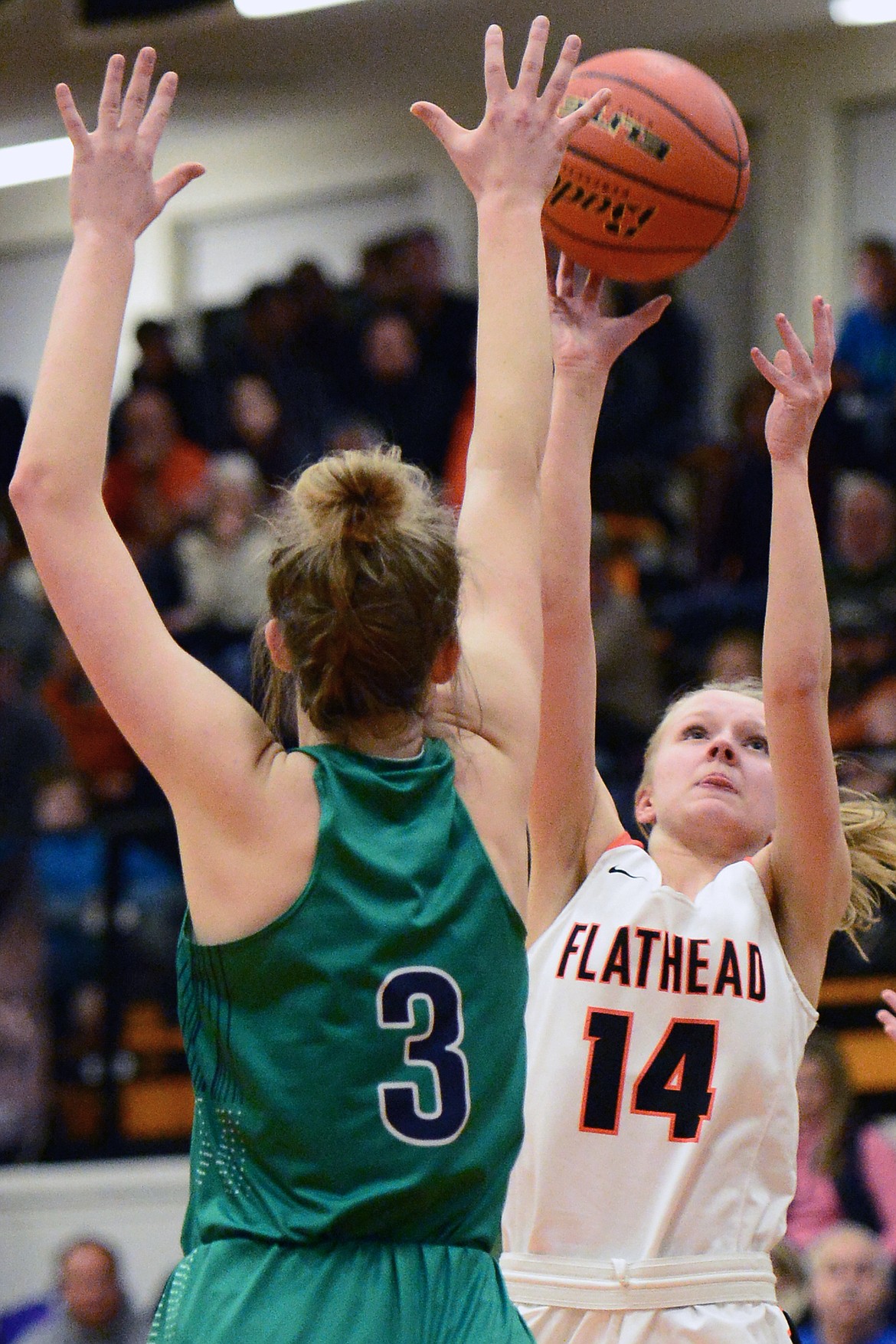 Flathead's Jenna Johnson (14) looks to shoot against Glacier's Kali Gulick (3) during a crosstown matchup at Flathead High School on Tuesday. (Casey Kreider/Daily Inter Lake)