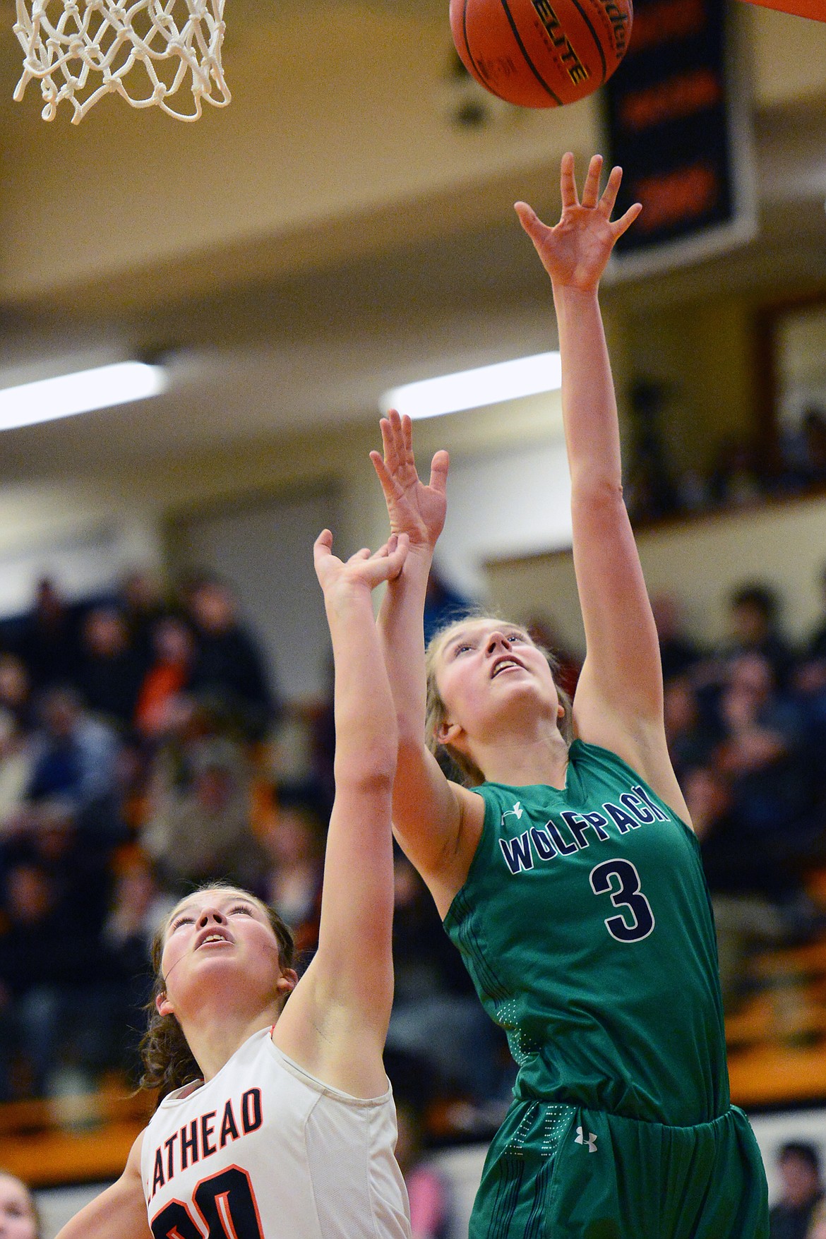 Glacier's Kali Gulick (3) goes to the hoop over Flathead's Bridget Crowley (20) during a crosstown matchup at Flathead High School on Tuesday. (Casey Kreider/Daily Inter Lake)