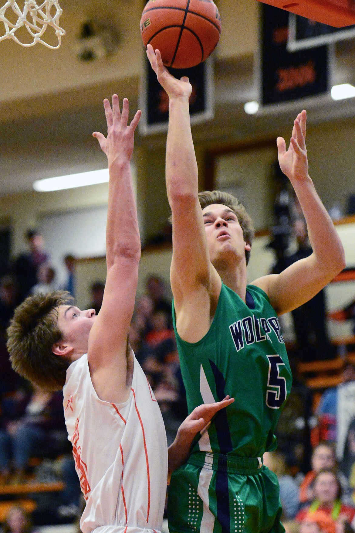 Glacier's Ethan Baines (5) drives to the hoop against Flathead's Tannen Beyl (5) during a crosstown matchup at Flathead High School on Tuesday. (Casey Kreider/Daily Inter Lake)