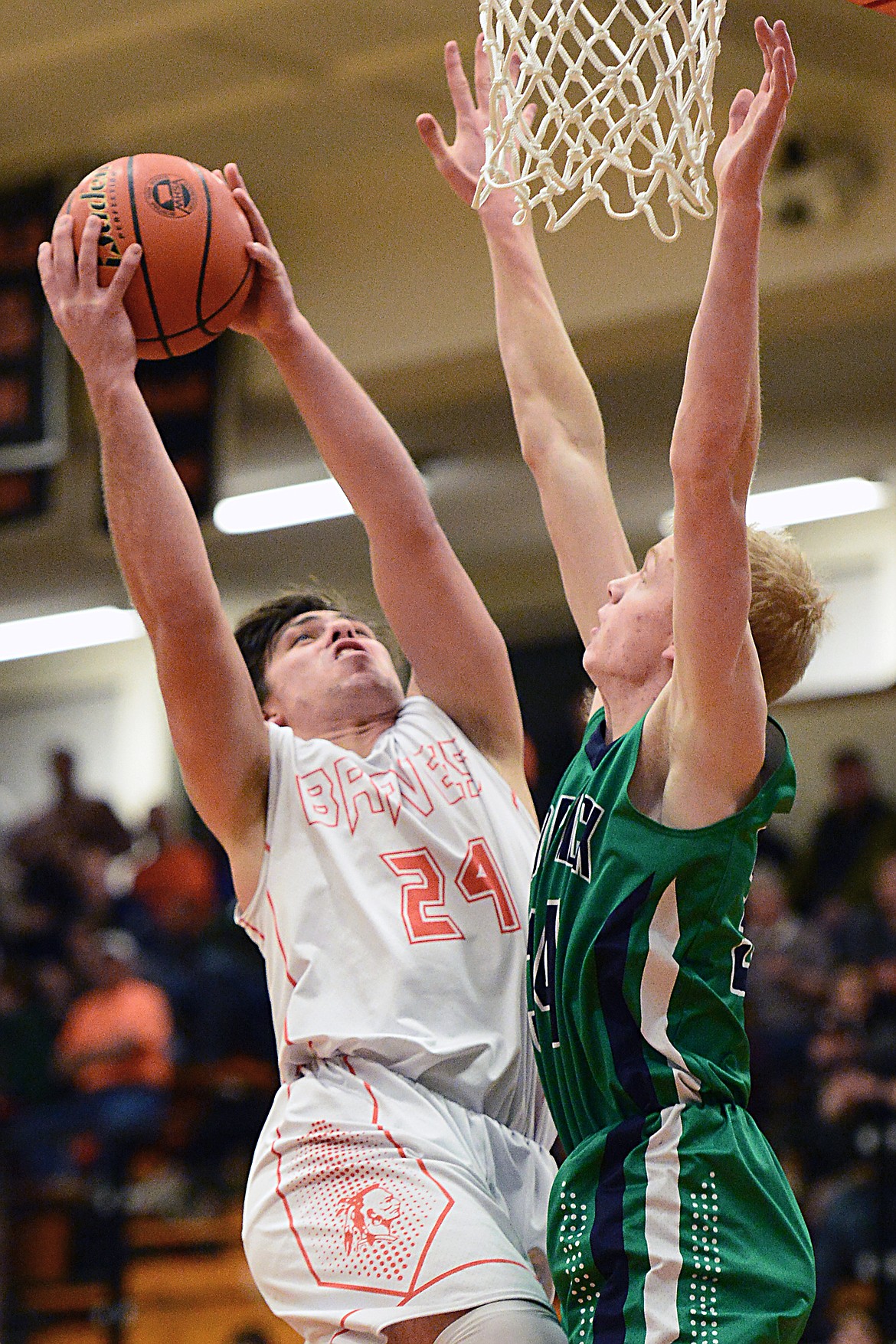 Flathead's Blake Counts (24) drives to the hoop against Glacier's Bret Michaels (34) during a crosstown matchup at Flathead High School on Tuesday. (Casey Kreider/Daily Inter Lake)