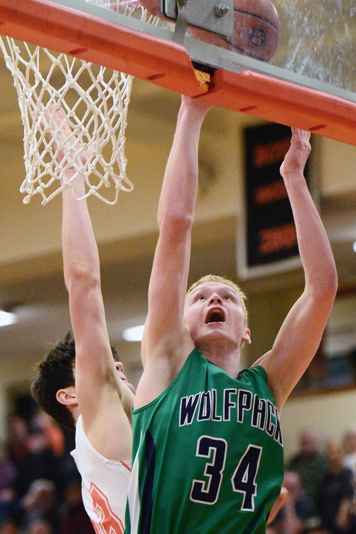 Glacier's Bret Michaels (34) goes to the hoop in front of Flathead's Gabe Adams (33) during a crosstown matchup at Flathead High School on Tuesday. (Casey Kreider/Daily Inter Lake)