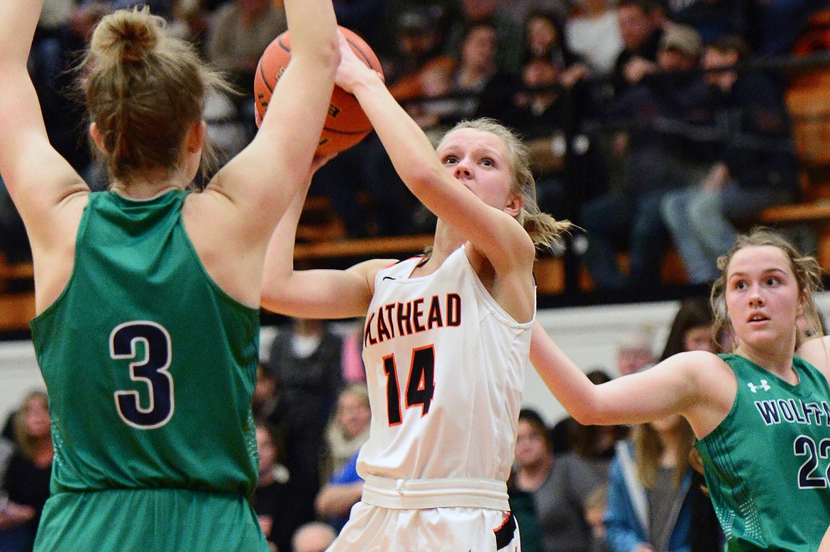 Flathead's Jenna Johnson (14) drives to the basket against Glacier's Kali Gulick (3) during a crosstown matchup at Flathead High School on Tuesday. (Casey Kreider/Daily Inter Lake)