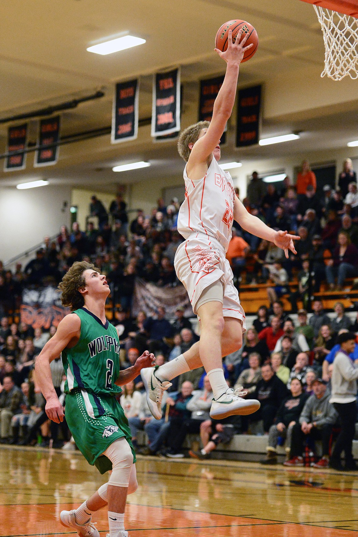 Flathead's Seth Moon (22) heads to the hoop in front of Glacier's Drew Deck (2) during a crosstown matchup at Flathead High School on Tuesday. (Casey Kreider/Daily Inter Lake)