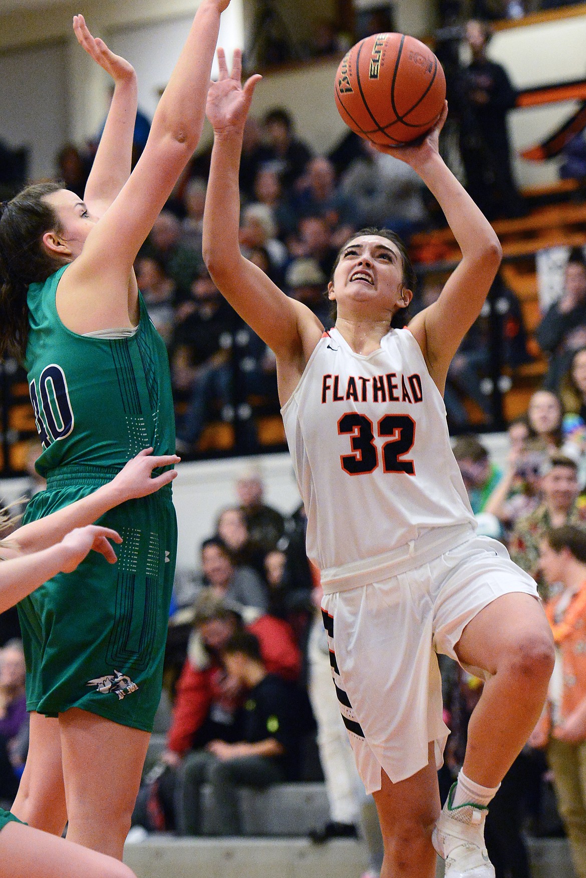 Flathead's Taylor Henley (32) drives to the hoop against Glacier's Raley Shirey (40) during a crosstown matchup at Flathead High School on Tuesday. (Casey Kreider/Daily Inter Lake)