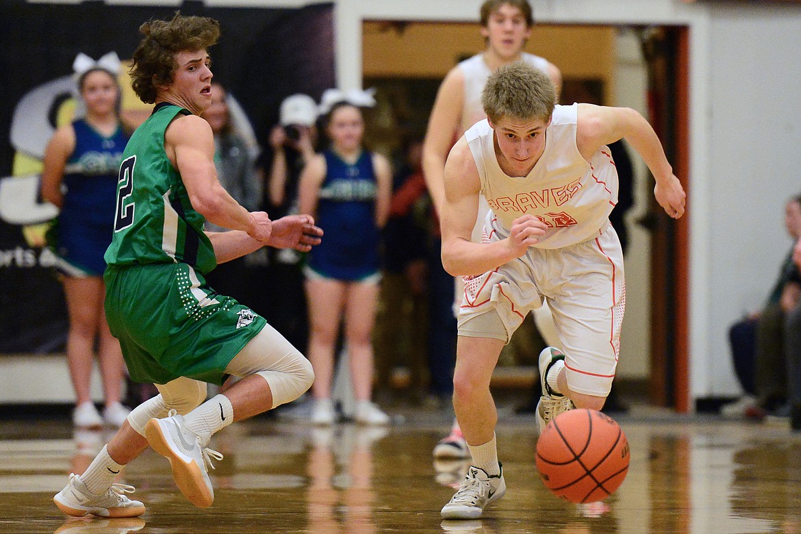 Flathead's Seth Moon (22) steals the ball from Glacier's Drew Deck (2) during a crosstown matchup at Flathead High School on Tuesday. (Casey Kreider/Daily Inter Lake)