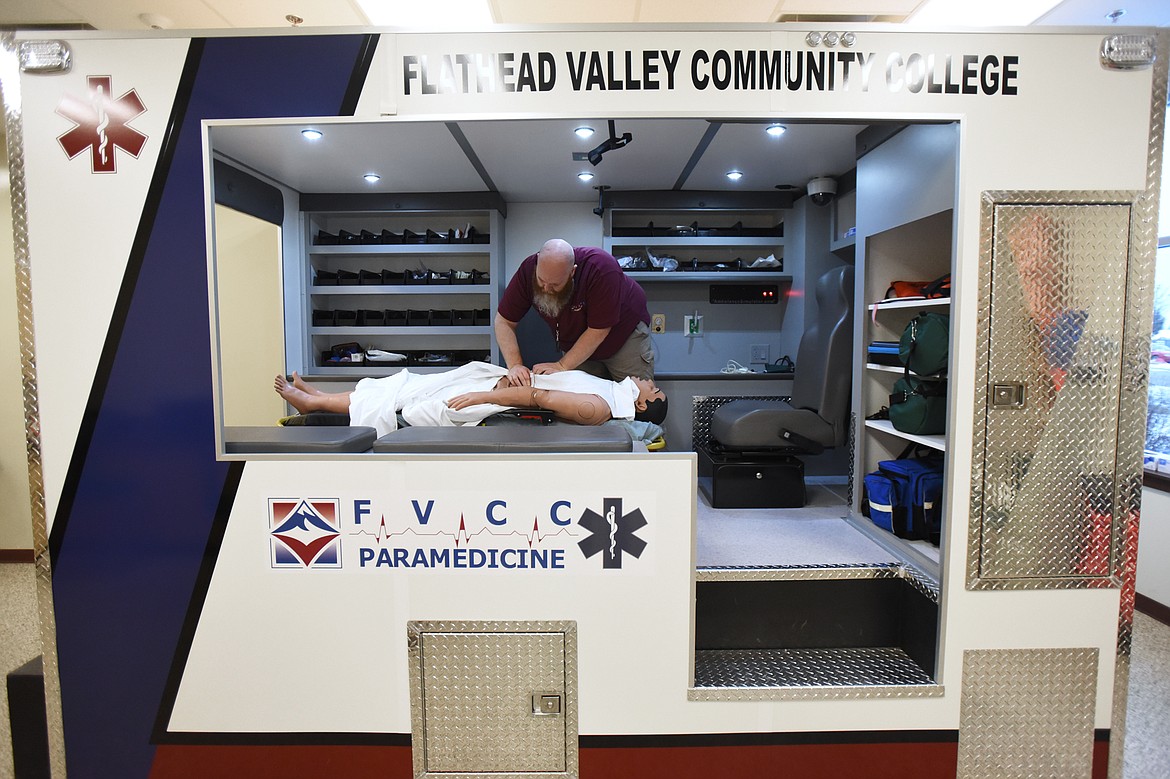 Richie Berndt, lab coordinator and paramedic instructor, works inside the ambulance simulator during a tour of the paramedicine lab.