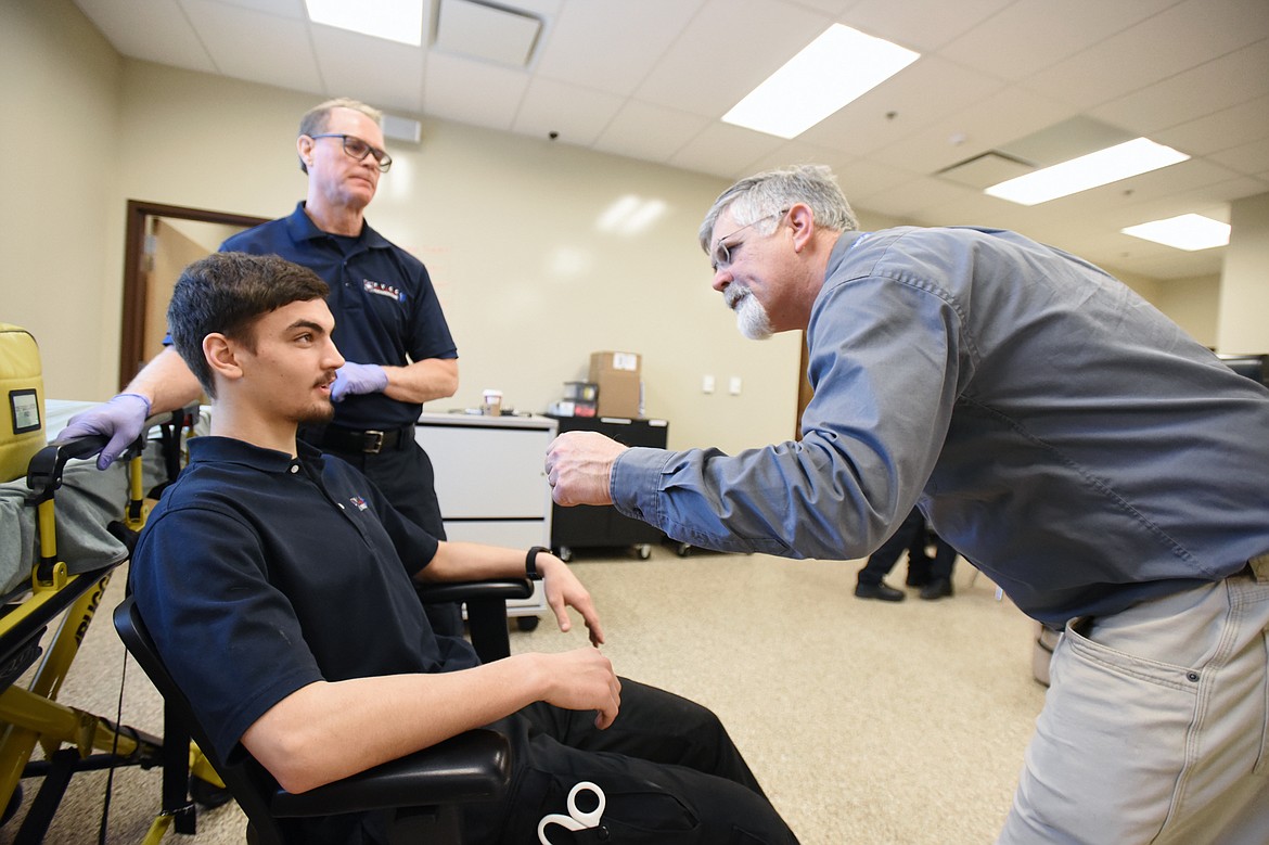 Doug Petch, right, clinical coordinator of the paramedicine program at FVCC, instructs students Victor Loff, seated, and Tim Olson during a primary assessment at the paramedicine lab at Flathead Valley Community College on Thursday, Jan. 31. (Casey Kreider/Daily Inter Lake)
