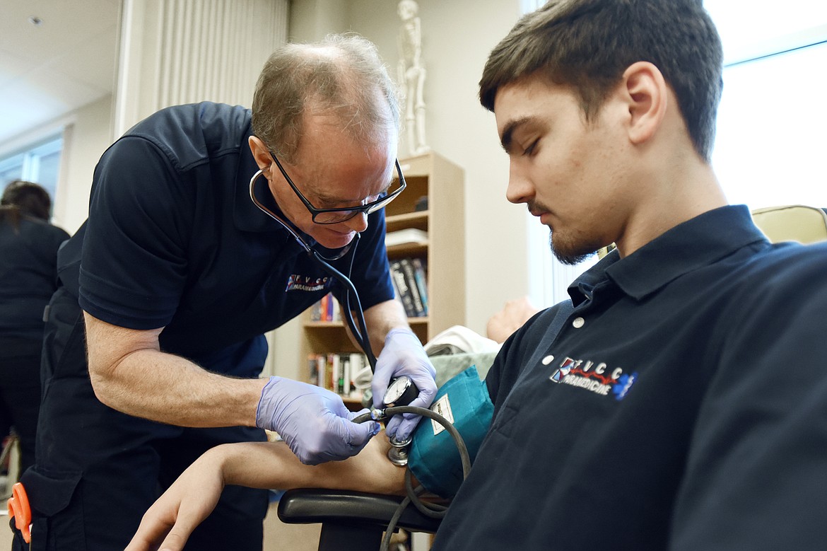 Tim Olson, left, checks the pulse of fellow student Victor Loff as part of a primary assessment during a tour of the paramedicine lab at Flathead Valley Community College on Thursday, Jan. 31. (Casey Kreider/Daily Inter Lake)