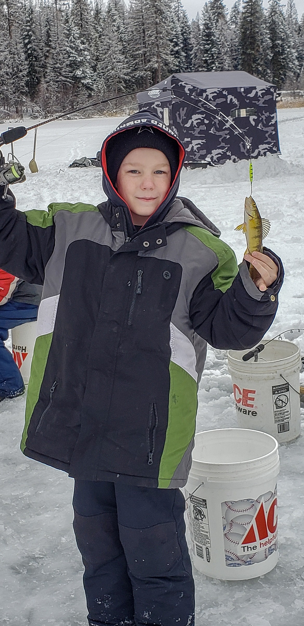 Damion Conroy shows off his catch during the Hooked on Fishing program at Lower Thompson Chain of Lakes State Park Jan. 18. (Rima Austin/The Western News)