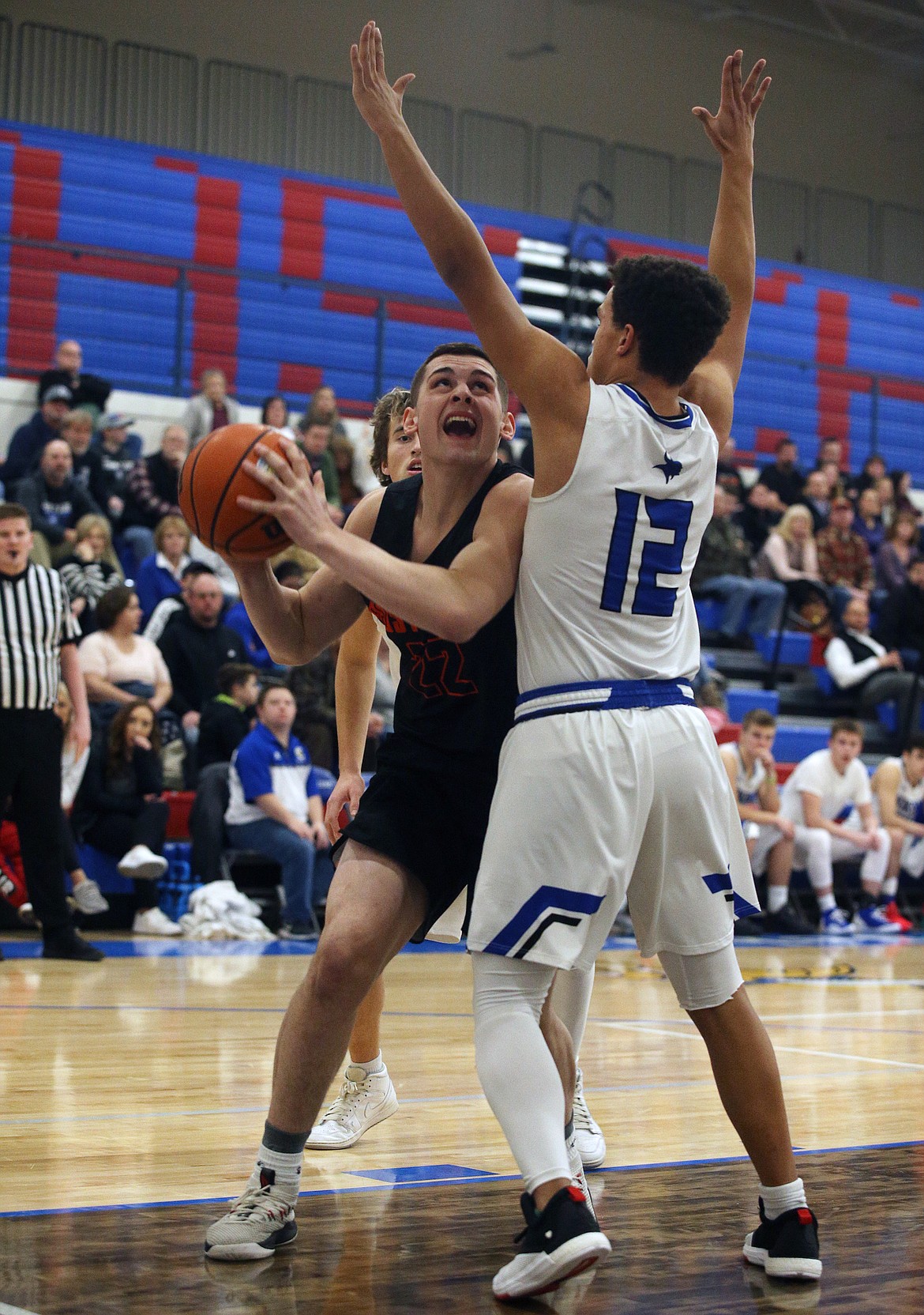 Gavven Desjarlais of Post Falls drives towards the basket as Coeur d'Alene's Devon Johnson blocks during the first half of Thursday night's game at Viking Court. (LOREN BENOIT/Press)