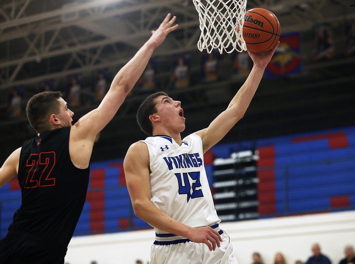 Coeur d'Alene's Kale Edwards scores on a layup in the second half of Thursday night's game against Post Falls at Viking Court. (LOREN BENOIT/Press)