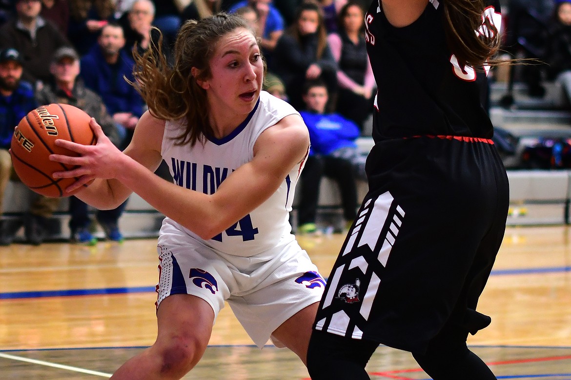 Josie Windauer looks to make a pass after securing a rebound against the Lady Indians Saturday. (Jeremy Weber photo)