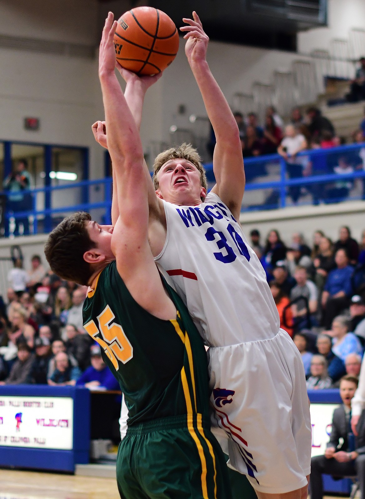 Zack Pletcher takes the ball up against Whitefish&#146;s Dillon Botner Thursday. (Jeremy Weber photo)