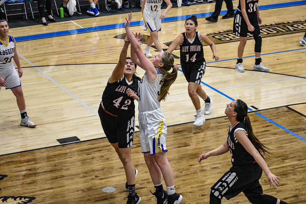 Libby senior McKenzie Proffitt is fouled by Browning's Tamika Guardipee before going 1 for 2 at the free throw line during the third quarter against Browning Saturday. (Ben Kibbey/The Western News)