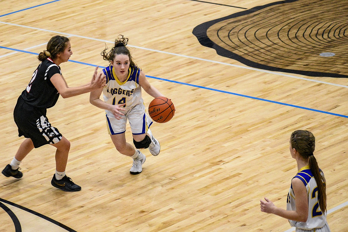 Libby senior Emma Gruber looks to Libby senior Linsey Walker before passing to her in the third quarter against Browning Saturday. (Ben Kibbey/The Western News)