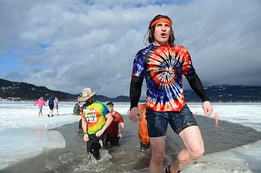 Participants step out of Whitefish Lake during the Whitefish Winter Carnival Penguin Plunge 2019 on Saturday. (Casey Kreider/Daily Inter Lake)