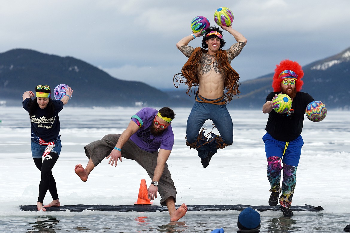 Participants leap into Whitefish Lake during the Whitefish Winter Carnival Penguin Plunge 2019 at City Beach on Saturday. (Casey Kreider/Daily Inter Lake)