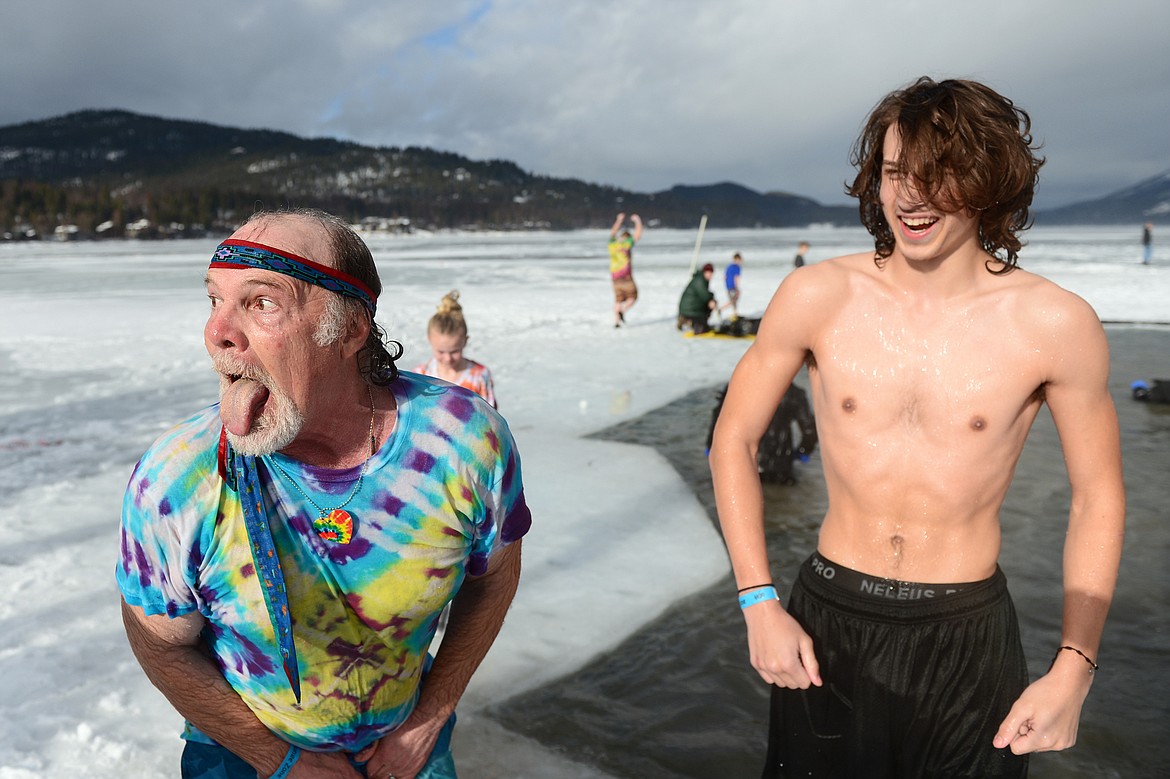 Paul Coats, left, King Ullr LX in the Whitefish Winter Carnival Royal Court, steps out of Whitefish Lake during the Whitefish Winter Carnival Penguin Plunge 2019 on Saturday. (Casey Kreider/Daily Inter Lake)